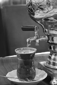 Close-up of turkish tea by teapot on table