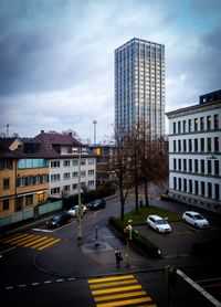 View of city street and buildings against sky