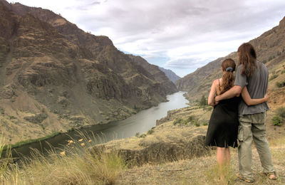 Rear view of couple looking at valley in hells canyon