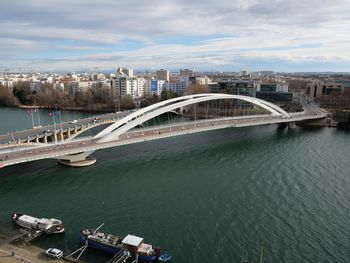 High angle view of bridge over river amidst buildings in city