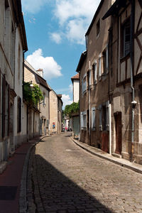 Empty road amidst buildings in town