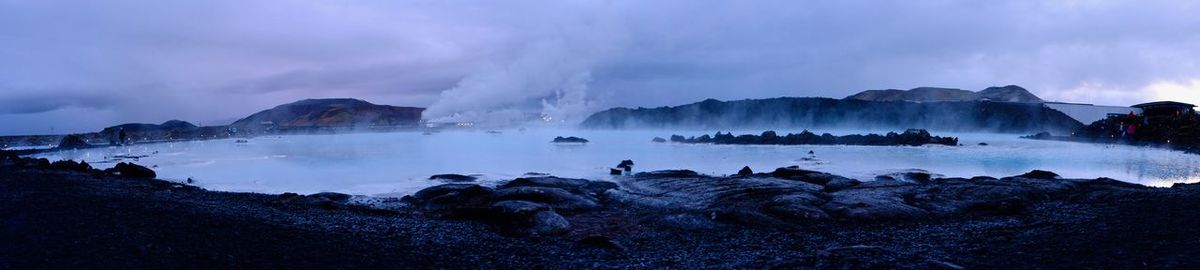 Panoramic view of people on mountains against sky