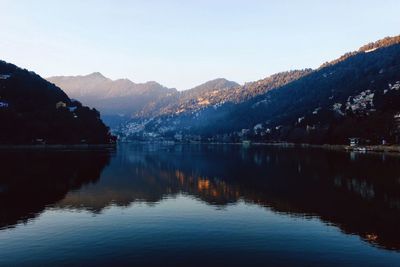 Scenic view of lake and mountains against clear sky