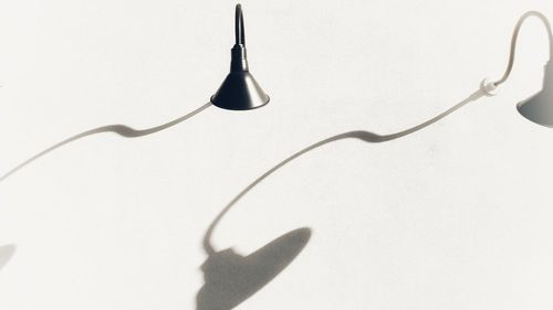 Close-up of shadow on table against white background