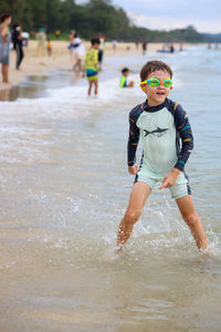 Rear view of man standing in sea