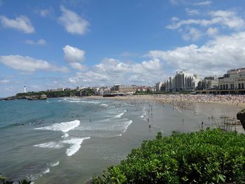 Scenic view of beach against sky in city