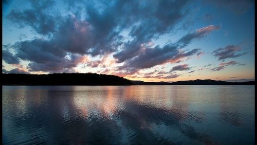 Scenic view of lake at sunset