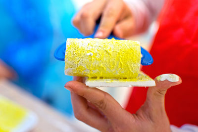 Close-up of hand holding ice cream