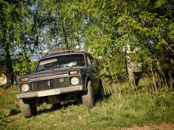 Abandoned car on field