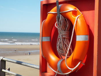 Close-up of inflatable ring hanging on wall at beach