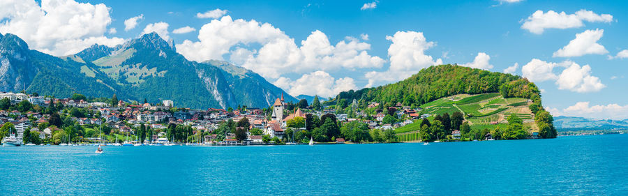 Scenic view of sea and mountains against sky