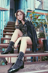 Portrait of young woman sitting on staircase