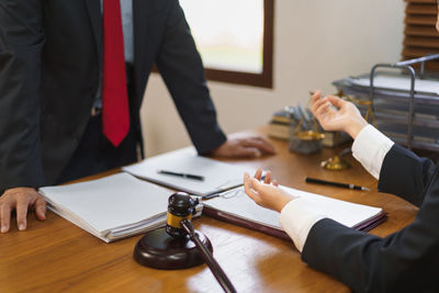 Midsection of lawyer shaking hands