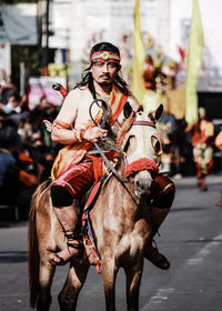 Rear view of man riding horse