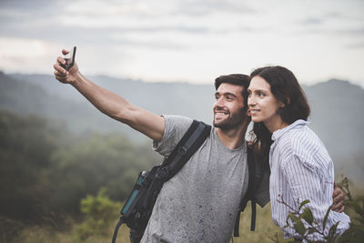 Young man photographing at camera