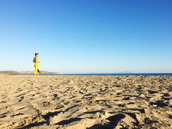 Woman standing against sea at beach