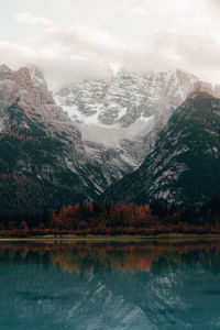 Scenic view of lake and snowcapped mountains against sky