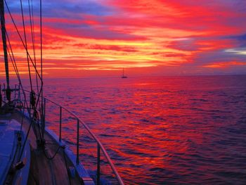 Sailboat in sea at sunset