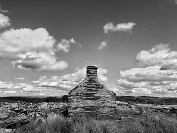 Old ruin on field against sky