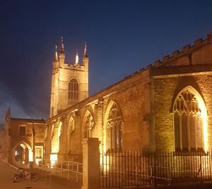Low angle view of illuminated building against sky at night
