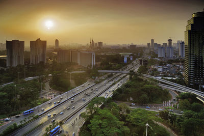 High angle view of street amidst buildings in city against sky