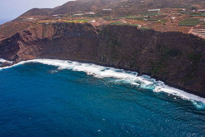 Scenic view of sea by mountain