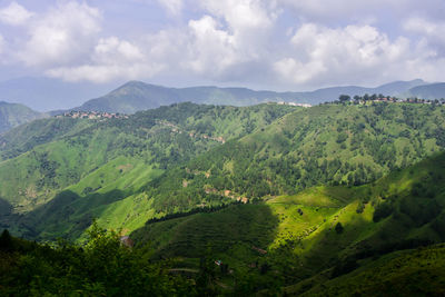 High angle view of green landscape against sky