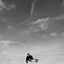 Low angle view of woman standing against sky