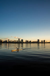 Scenic view of river against clear sky during sunset