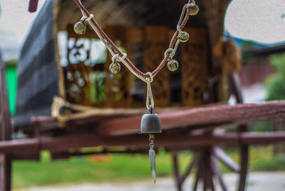 Close-up of cross hanging on wood