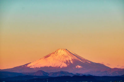 Scenic view of snowcapped mountains against blue sky