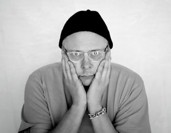 Portrait of man wearing eyeglasses against white background