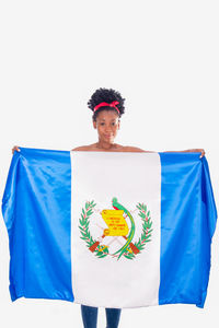 Portrait of smiling man holding umbrella against white background