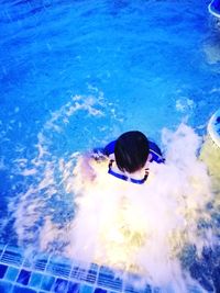 High angle view of woman swimming in pool