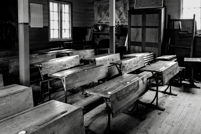 Empty chairs and table in old building