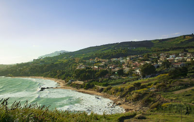 Scenic view of landscape and mountains against clear sky