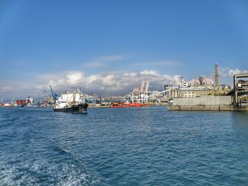 Commercial dock by sea against sky