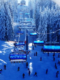 Overhead cable cars at snow covered landscape