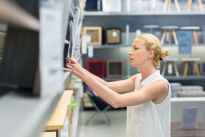 Mid adult woman standing in departmental store