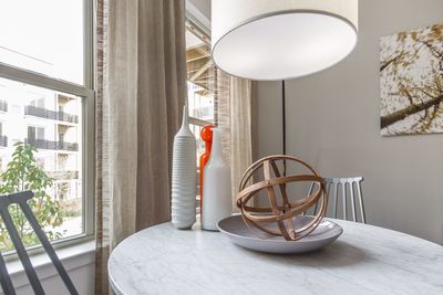 Wooden spherical decoration on plate on table at home