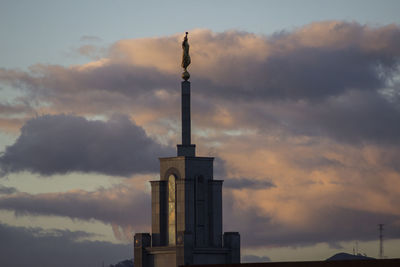 Low angle view of building against cloudy sky