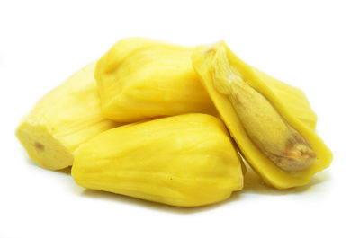 Close-up of fresh yellow slices over white background