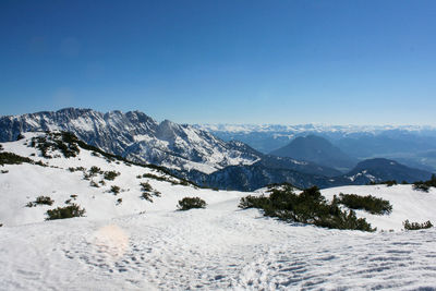 Scenic view of snowcapped mountains against clear blue sky