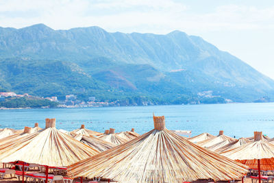 Beach umbrellas made by dry reed . touristic resort on the tropical coast