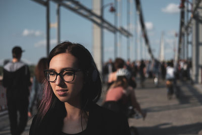 Close-up of young woman against sky