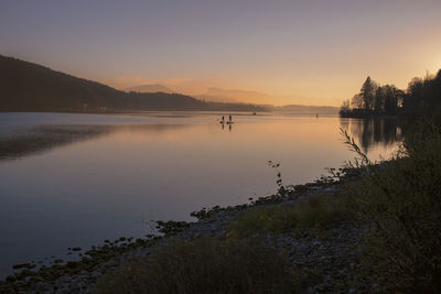 Scenic view of lake against sky during sunset