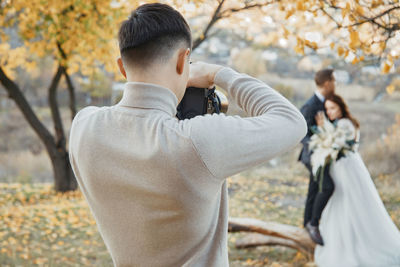 Side view of young woman looking at park