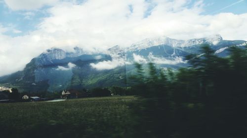 Scenic view of mountains against cloudy sky