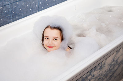 High angle portrait of smiling girl in bathtub 