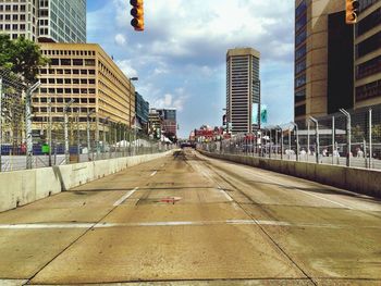 Empty road along buildings